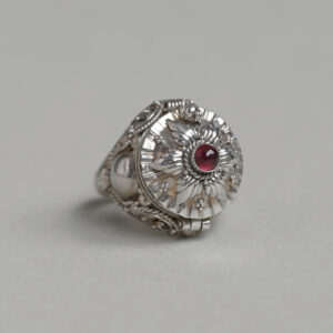 Decorative sterling silver opening locket ring with garnet cabochon