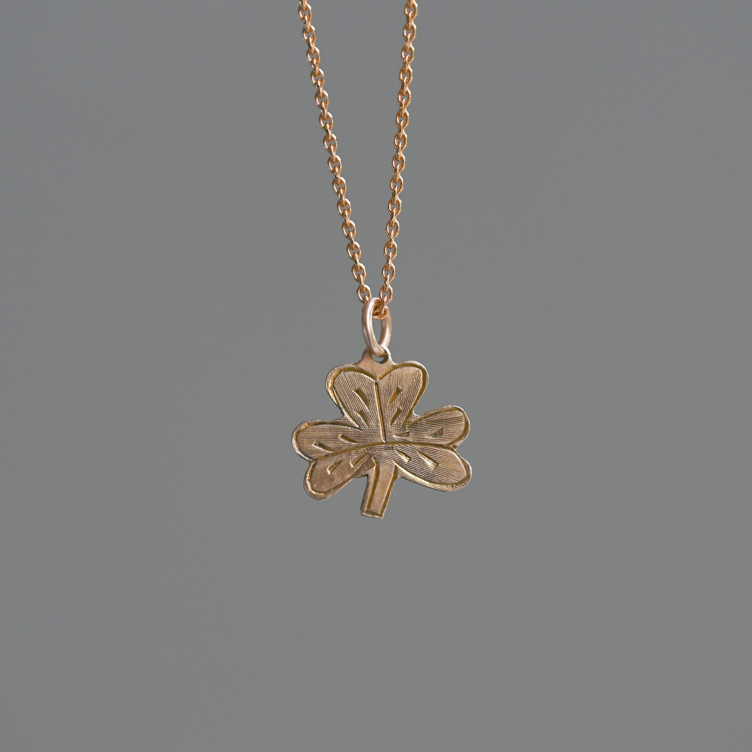 Cutie 9ct gold engraved clover charm pendant